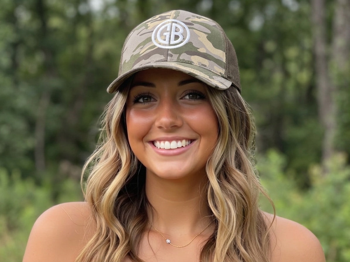 Gun Beaver Logo camo trucker cap, worn by female model